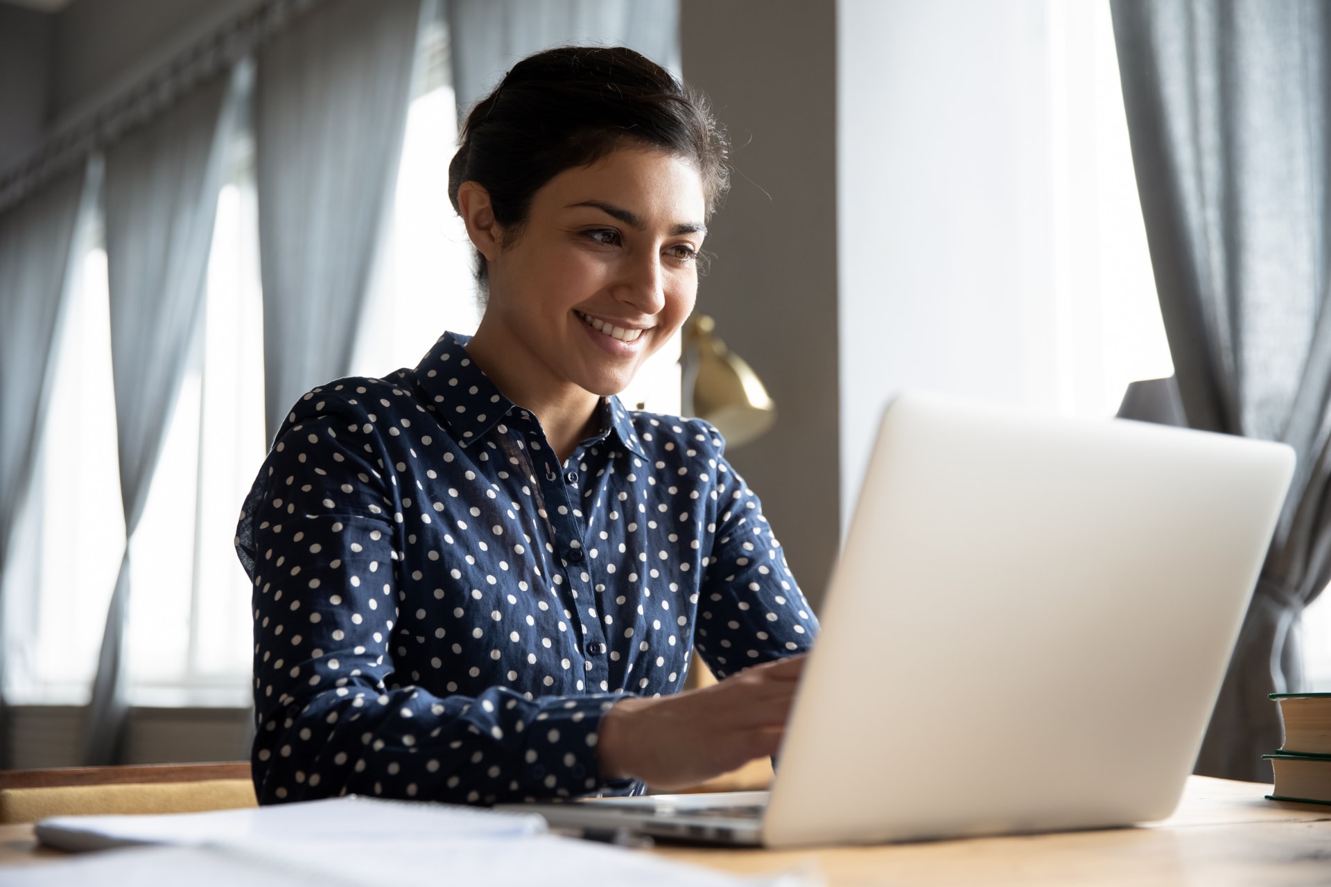 Woman in office environment with laptop